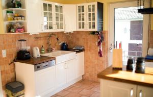 a kitchen with white cabinets and a sink at Charmantes Turmzimmer 