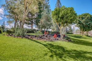 a garden with trees and flowers in a yard at Waikoloa Fairways C119 in Waikoloa Village