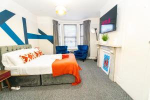 a bedroom with a bed and a fireplace at Bright Medway studio flat opposite Chatham station in Chatham