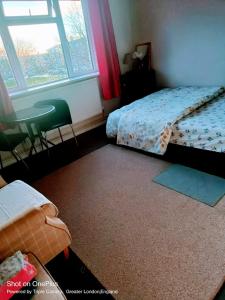 a bedroom with a bed and a chair and a window at London's bed with breakfast in London