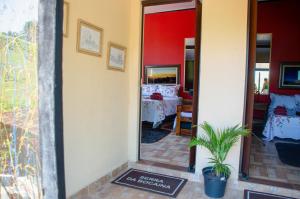 a hallway leading to a room with a bedroom at Pousada Estância Vip in Cunha