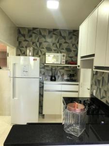 a kitchen with white cabinets and a white refrigerator at Melhor Localização! Botafogo-URCA in Rio de Janeiro