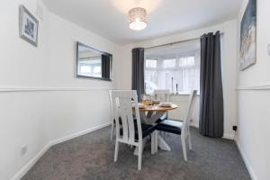 a dining room with a table and chairs and a window at Jesmond Square in Hartlepool