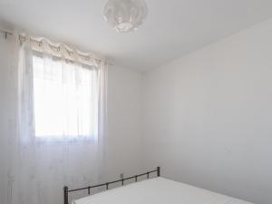 a white room with a window and a bed at Appartement 4 Pers. Terrasse Clim, Piscine Collective - FR-1-535-37 in Châtelaillon-Plage +3 photos
