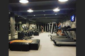a gym with rows of treadmills and exercise bikes at Enjoy Samui Residences（Pause on Samui） in Koh Samui 