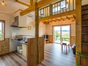 a kitchen and living room with wooden beams at Country Cottage Waki Aiai - Vacation STAY 26548v in Sorachi