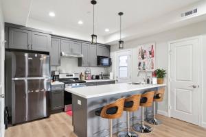 a kitchen with stainless steel appliances and a counter at Incredible Value for 12 guests, New 3BR Home by Disneyland, Knott's, Beach in Midway City