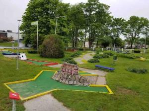 a small playground with a small house in a park at Spacious Oceanview Villa (Sleeps 22) in New London