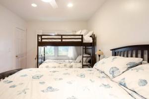 a bedroom with two bunk beds and a window at Spacious Oceanview Villa (Sleeps 22) in New London