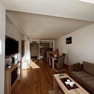a living room with a couch and a table at Gondola Neda Lux in Zlatibor