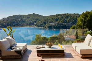 a patio with a view of a lake and mountains at Villa Zinnia in Skiathos Town