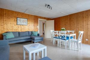 a living room with a couch and a table at Chalet Seehus Iseltwald in Iseltwald