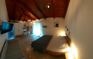 a bedroom with a large bed and a living room at Patra Studio B4 in Patra
