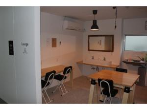 a room with a table and chairs and a sink at Guesthouse Banvina - Vacation STAY 03952v in Kagoshima