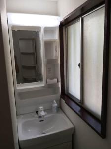 a bathroom with a sink and a mirror at Bouldering & SPA -Ariki Resort Shuzenji ANNEX- - Vacation STAY 07698v in Izu