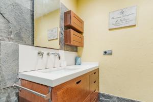 a bathroom with a sink and a mirror at La terrazuca in Santander +14 photos