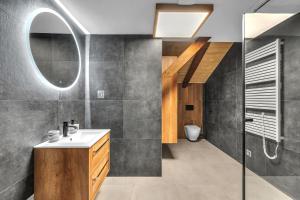 a bathroom with a sink and a mirror at Hotel U Krále Jiřího in Stráž pod Ralskem