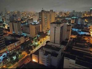 a city at night with buildings and street lights at Loft centro de Goiânia 1108 in Goiânia