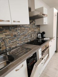 a white kitchen with a sink and a stove at Riazanska Residence 3 room Free Wi-Fi in Bratislava