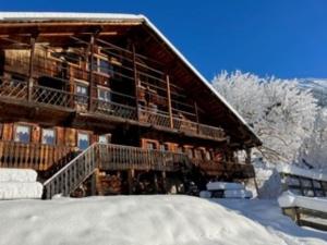 a large log cabin with snow on the ground at Chalet 4 pièces avec balcon, BBQ, parking, WIFI à Châtel - FR-1-676-43 in Châtel