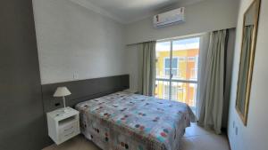 a bedroom with a bed and a large window at B720 - Apartamento 2 quartos em cond. com piscina in Bombas +37 photos