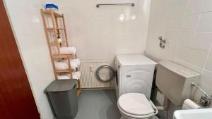 a small bathroom with a toilet and a sink at Privatunterkunft in Uetersen bei Hamburg in Uetersen +12 photos