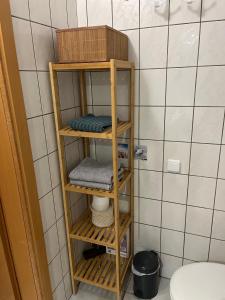 a wooden shelf in a bathroom with a toilet at Strandstern Norddeich in Norddeich