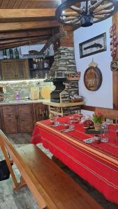 a kitchen with a table with a red table cloth at Къща под наем-нощувки in Targovishte