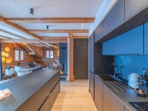 LʼHuezにあるChalet de luxe, spa, ski aux pieds, Alpe d'Huez - FR-1-645-48のキッチン(大きなカウンター付)、リビングルームが備わります。