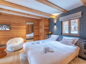 LʼHuezにあるChalet de luxe, spa, ski aux pieds, Alpe d'Huez - FR-1-645-48の木製の壁の客室で、白い大型ベッド1台が備わります。 +8枚の写真