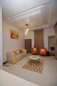 a living room with a couch and a table at Chic sanctuary & tranquil oasis in Lekki