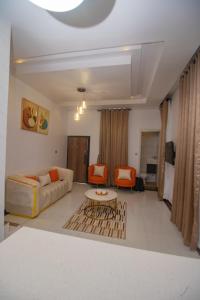 a living room with a couch and a table at Chic sanctuary & tranquil oasis in Lekki