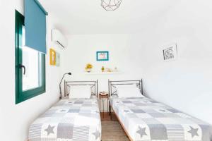 two beds sitting next to each other in a room at Villa Zinnia in Skiathos Town