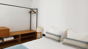 a bedroom with a bed with white sheets and pillows at Aeifos Boutique Hotel in Imerovigli