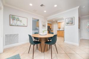 a kitchen and dining room with a table and chairs at Luxurious Fort Lauderdale Pool Home in Fort Lauderdale
