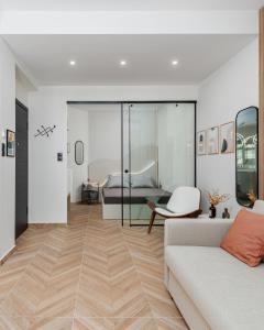 a living room with a couch and a bed at Oasis Diamond Suite in Thessaloniki