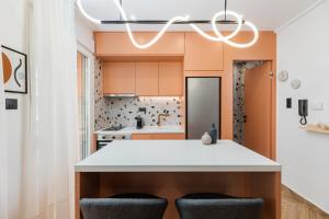 a kitchen with a white table and two chairs at Oasis Diamond Suite in Thessaloniki +16 photos