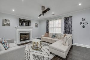 a living room with a couch and a fireplace at College Park Home 13 Mi to Downtown Atlanta! in College Park