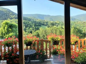a view from the porch of a house with flowers at Espectacular Chalet de Montaña Pirineos, Burg in Burg