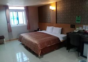 Letto o letti in una camera di Hua Xiang Motel - Arena