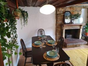 a dining room with a table and a fireplace at Bramblewick Cottage in Robin Hood's Bay