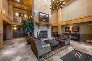 a large living room with a fireplace and furniture at Silverado Lodge by All Seasons Resort Lodging in Park City