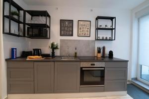 a kitchen with a sink and a counter top at Balance: Wohnung - Zentral - Messe - Stadion in Dortmund