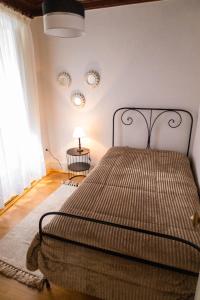 a bedroom with a bed in a room with a window at Casa da Praça de Murça in Murça