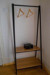 a shelf with a black stand with a radio on it at Casa da Praça de Murça in Murça