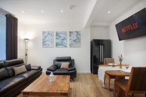a living room with a couch and a table at Selkies Retreat ✪ Grampian Lettings Ltd in Aberdeen