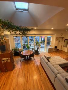 a living room with a couch and a table at Carriage House Williamsburg Brooklyn NYC HUGE STUDIO in Brooklyn