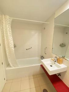 a white bathroom with a tub and a sink at Villa Hélice - Moderno apartamento en Cabo de Gata in Las Negras