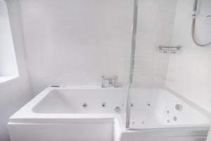 a white bathroom with a sink and a shower at Selkies Retreat ✪ Grampian Lettings Ltd in Aberdeen