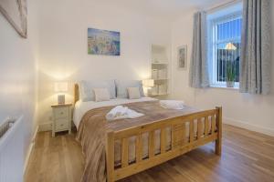 a bedroom with a bed with two towels on it at Selkies Retreat ✪ Grampian Lettings Ltd in Aberdeen